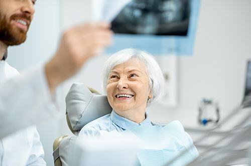 patient smiling while talking to dentist 