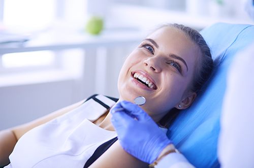 patient smiling while visiting dentist