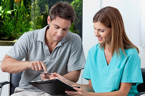  dental professional talking to patient 