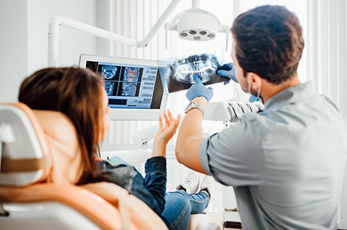 Dentist discussing a woman’s x-rays with her